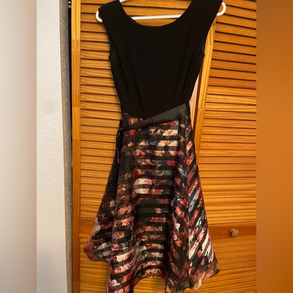 Black and floral tea-length dress with bow detailing.